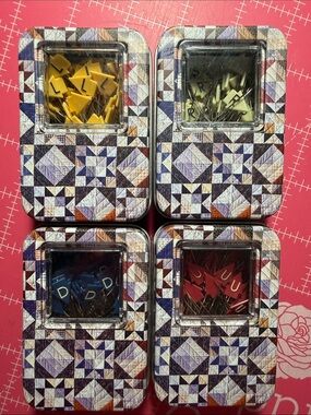 Quilters directional pins in collectors decorative tins.